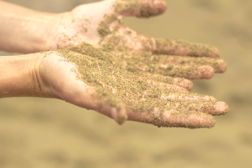 Hands at Green Sand Beach on the Big Island of Hawaii