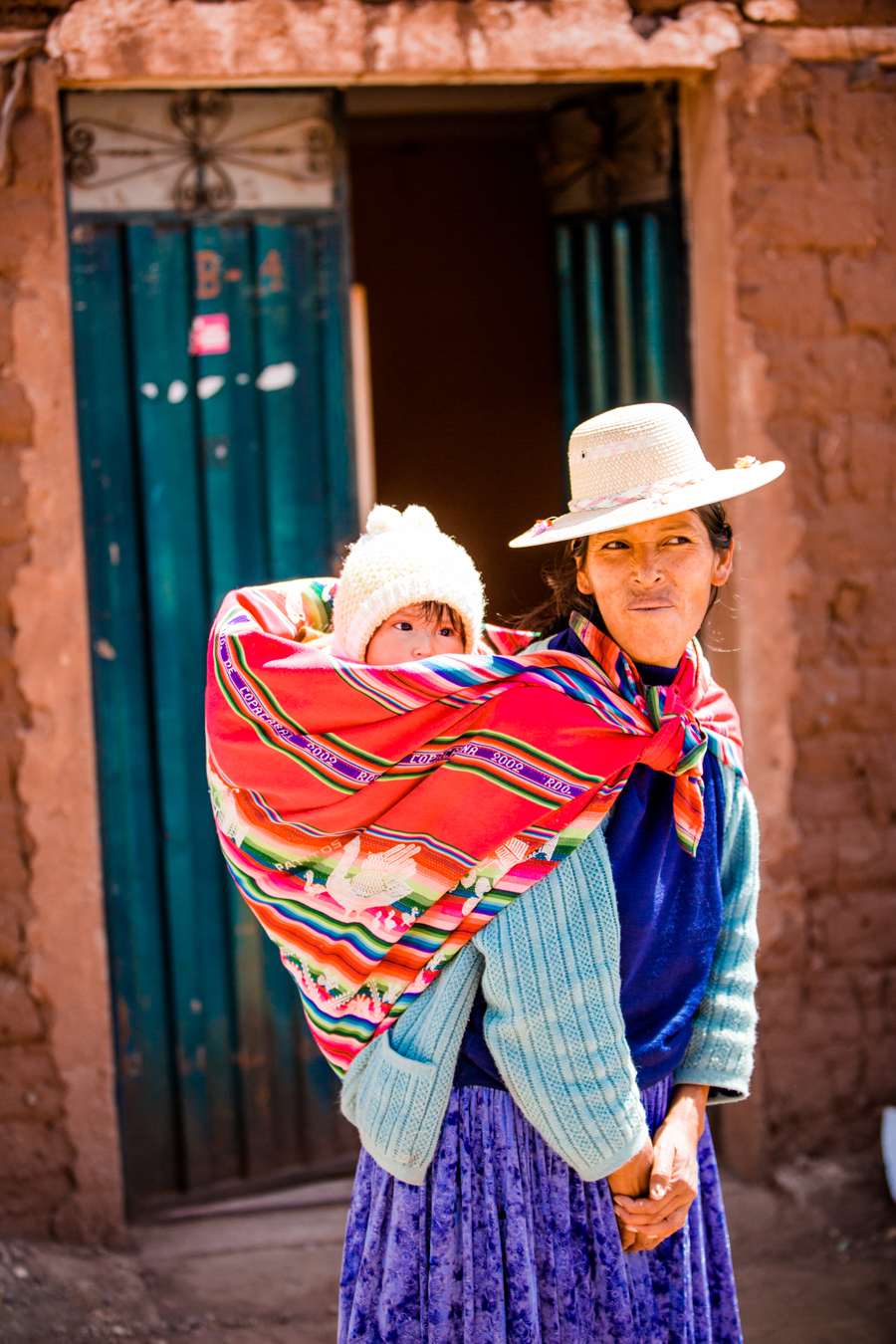 Woman Carrying Child in Peru