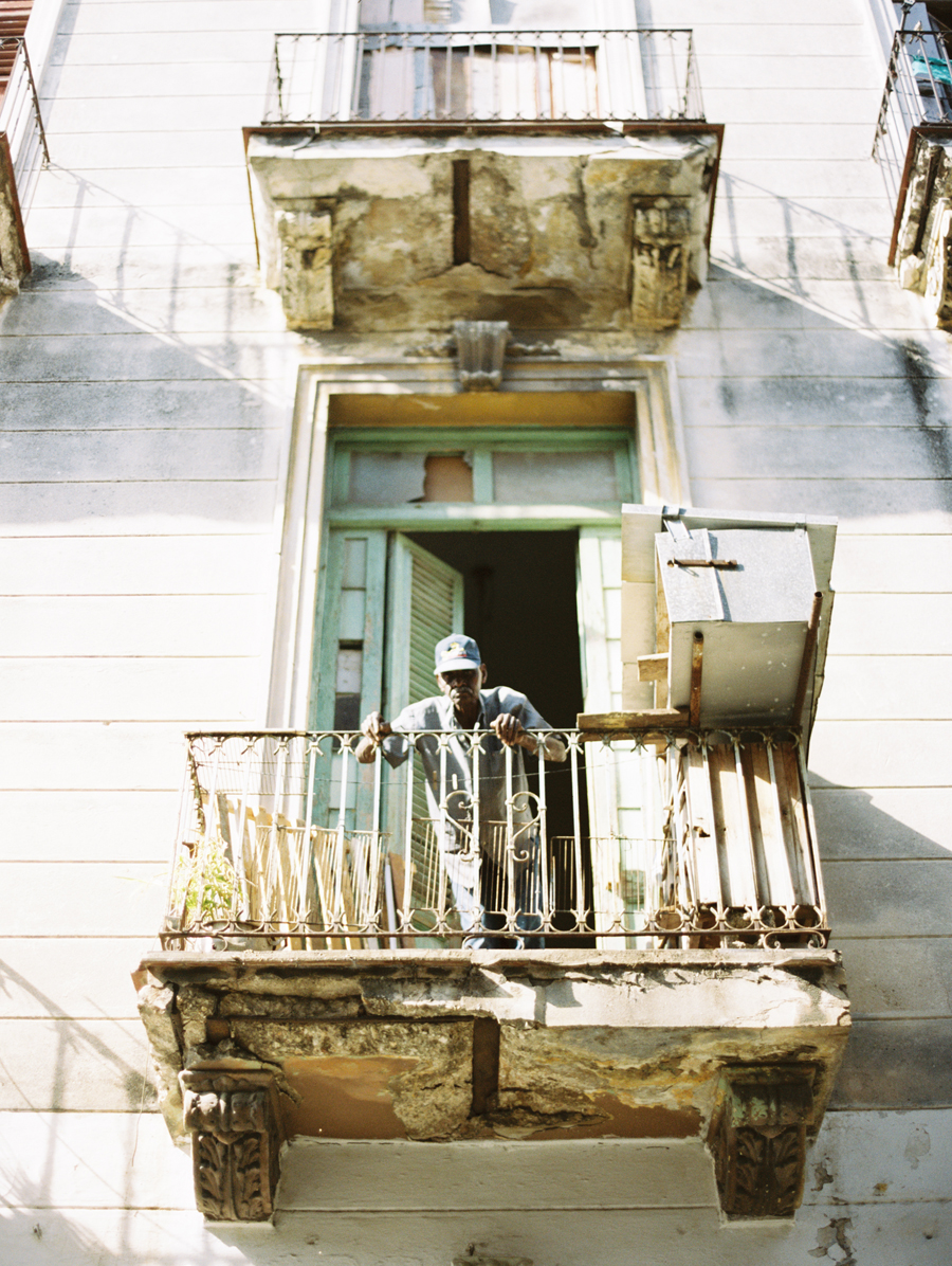 Man Standing on Balcony in Cuba